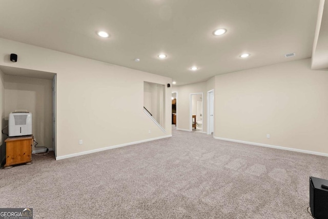 interior space with carpet floors, recessed lighting, and visible vents