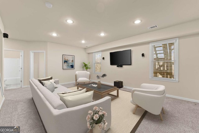 living room featuring recessed lighting, visible vents, baseboards, and light colored carpet