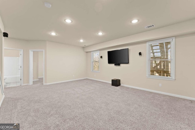 interior space featuring recessed lighting, visible vents, light carpet, and baseboards