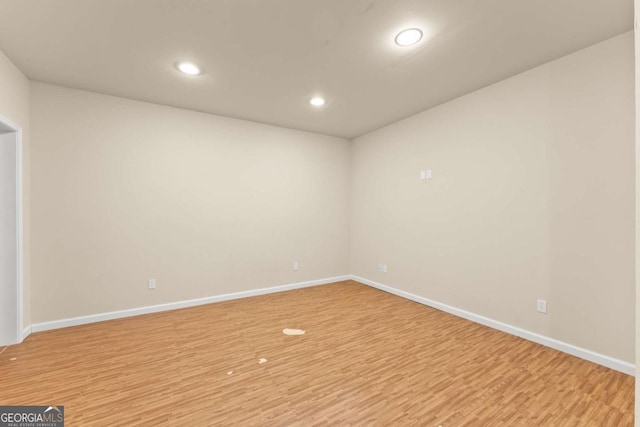 unfurnished room featuring baseboards, recessed lighting, and light wood-style floors