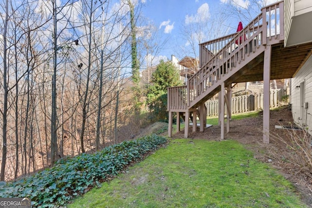 view of yard with fence and stairway