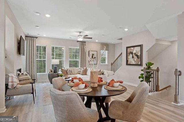 dining room with light wood-type flooring, baseboards, and recessed lighting