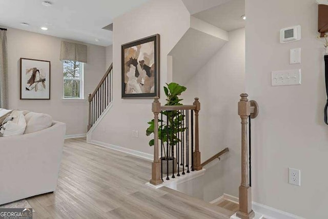 stairs featuring recessed lighting, baseboards, and wood finished floors