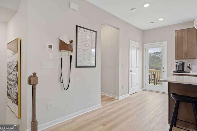 kitchen featuring light wood-style floors, baseboards, light countertops, and recessed lighting