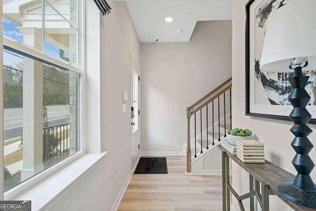 foyer entrance featuring stairway, recessed lighting, light wood-style flooring, and baseboards