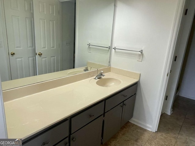 bathroom with baseboards and vanity