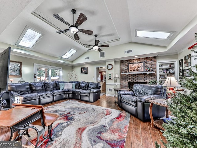 living area featuring dark wood-style floors, visible vents, vaulted ceiling, and built in features