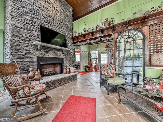 tiled living area with a high ceiling and a fireplace