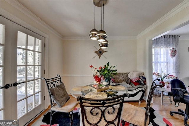 dining room featuring ornamental molding and wood finished floors