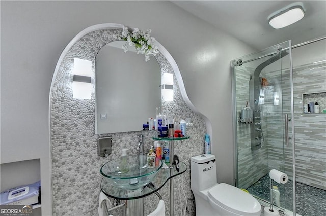 bathroom with toilet and a shower stall