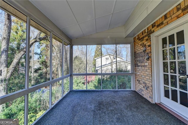 unfurnished sunroom featuring vaulted ceiling