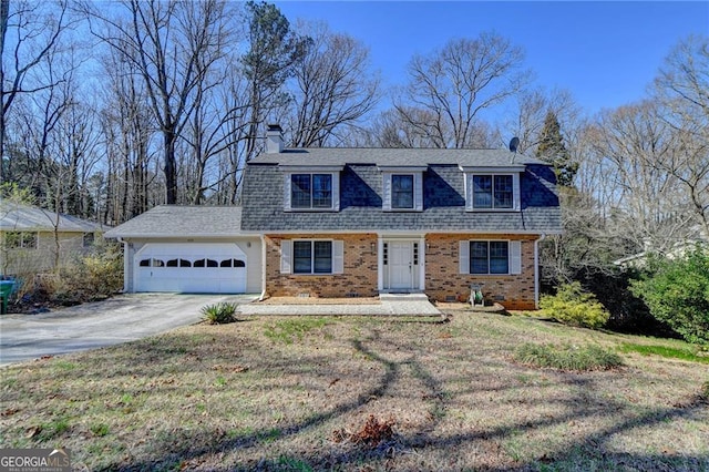 colonial inspired home featuring brick siding, a shingled roof, concrete driveway, a garage, and a front lawn