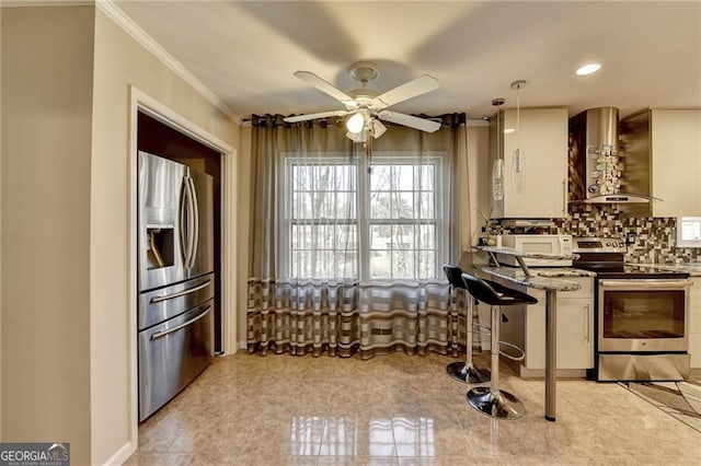 kitchen with stone counters, decorative backsplash, appliances with stainless steel finishes, white cabinetry, and wall chimney exhaust hood