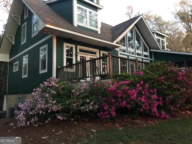 exterior space featuring central AC unit and a deck