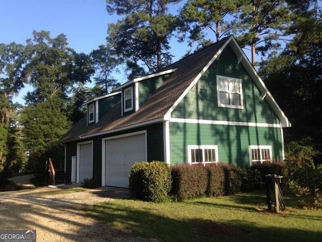 view of home's exterior featuring a garage and dirt driveway