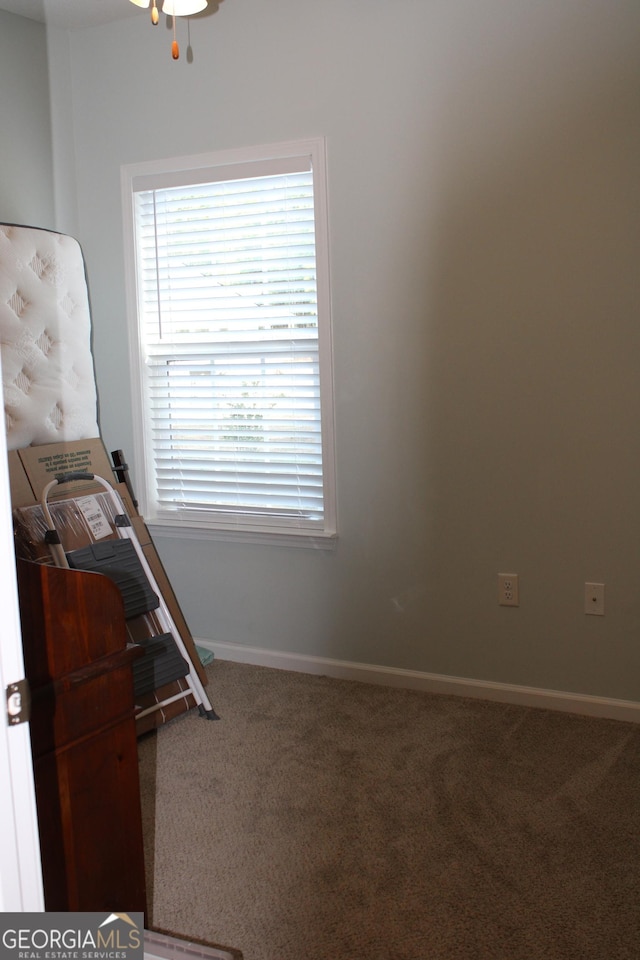 unfurnished bedroom with carpet floors and baseboards