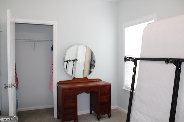 bedroom with carpet floors, a closet, and baseboards