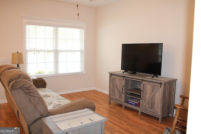 living area with wood finished floors and baseboards