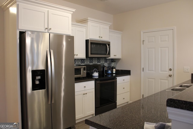 kitchen featuring a sink, appliances with stainless steel finishes, backsplash, and white cabinets