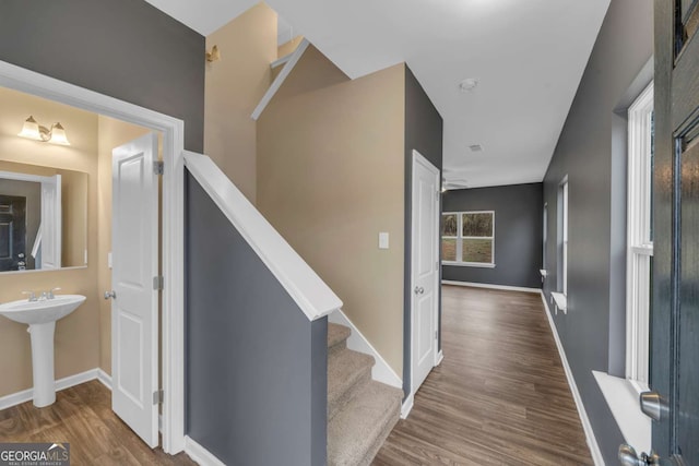 stairs featuring baseboards and wood finished floors