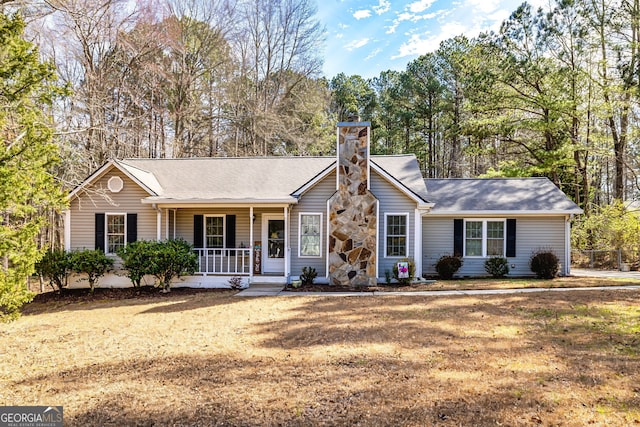 single story home with covered porch and a chimney