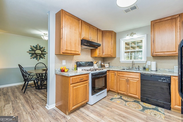 kitchen with under cabinet range hood, a sink, visible vents, black dishwasher, and gas range