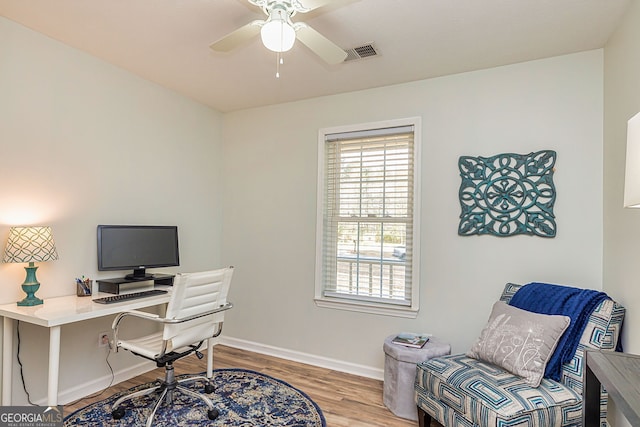 office area with visible vents, ceiling fan, baseboards, and wood finished floors