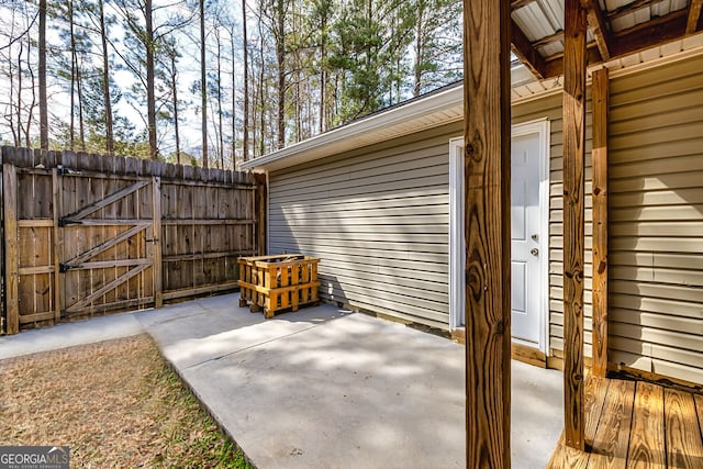 view of patio featuring a gate and fence