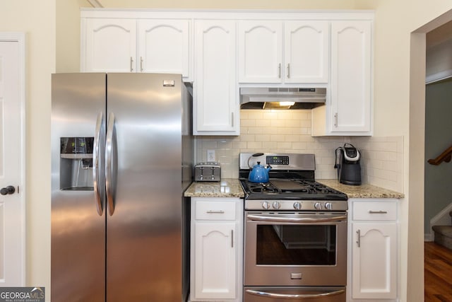 kitchen with stainless steel appliances, white cabinets, and under cabinet range hood