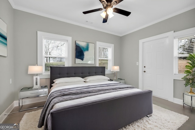 bedroom with ornamental molding, visible vents, and baseboards