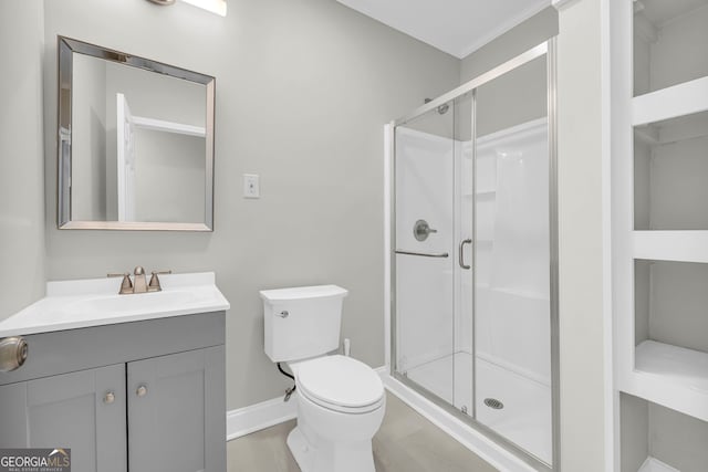 full bathroom with baseboards, a shower stall, toilet, and vanity