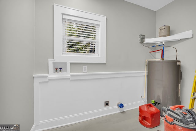 clothes washing area with water heater, laundry area, baseboards, and hookup for an electric dryer