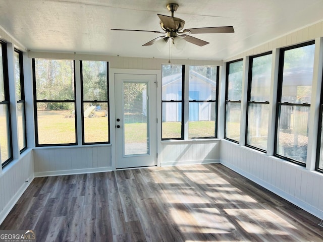 unfurnished sunroom featuring a ceiling fan