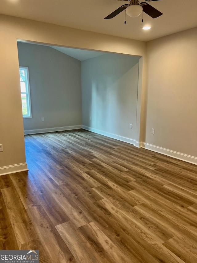 empty room featuring a ceiling fan, recessed lighting, dark wood-style flooring, and baseboards