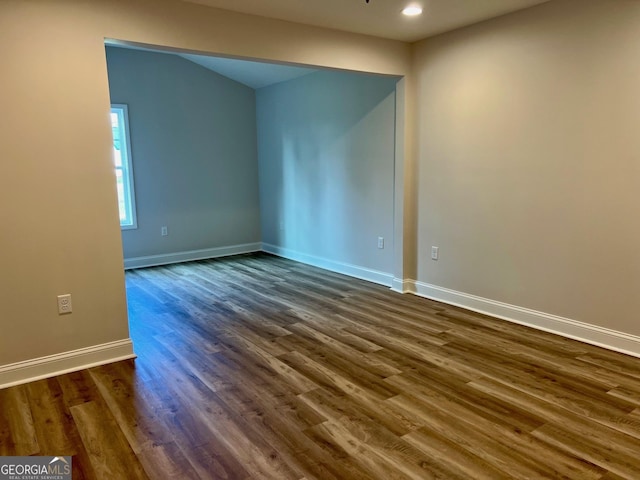 empty room with dark wood-style floors, recessed lighting, and baseboards