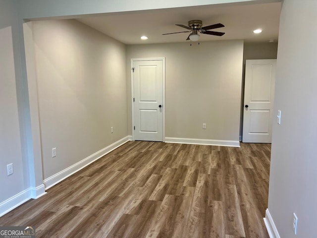 unfurnished room featuring a ceiling fan, baseboards, wood finished floors, and recessed lighting