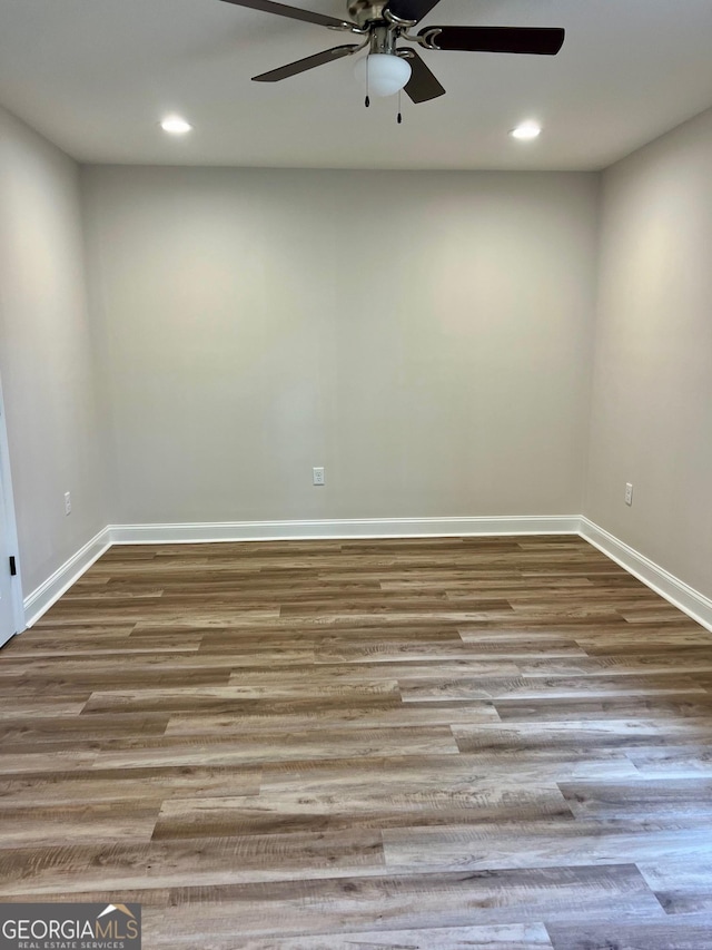 spare room featuring recessed lighting, light wood-style flooring, and baseboards