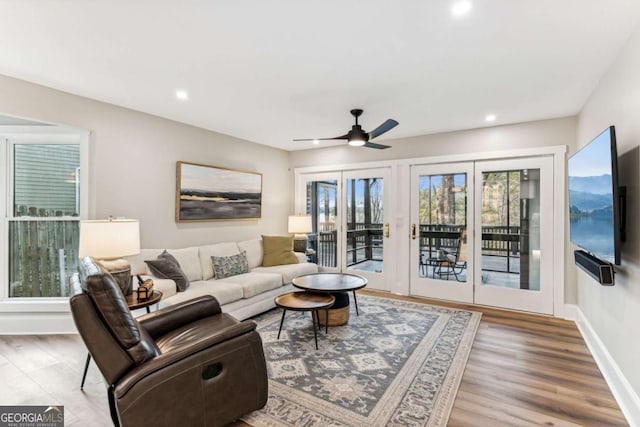 living room featuring a ceiling fan, recessed lighting, baseboards, and wood finished floors