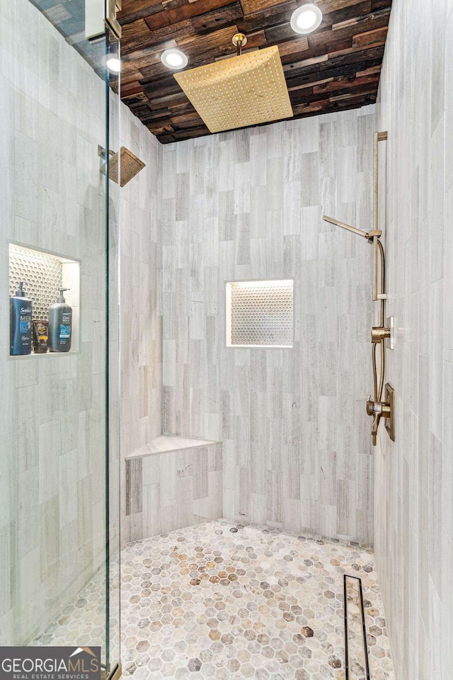bathroom featuring wooden ceiling and a tile shower