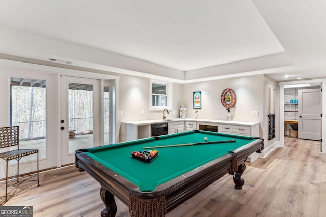 recreation room with french doors, visible vents, a sink, and light wood-style flooring