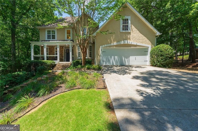 traditional-style home featuring stucco siding, a porch, and driveway