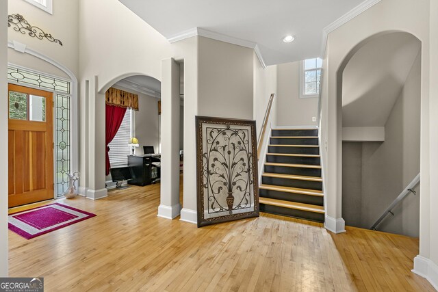 4010 Tamarack Dr NW, Kennesaw, GA 30152 - foyer featuring baseboards, wood-type flooring, arched walkways, and ornamental molding