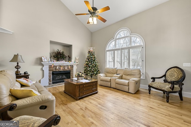 4010 Tamarack Dr NW, Kennesaw, GA 30152 - living area with baseboards, high vaulted ceiling, light wood-style flooring, ceiling fan, and a stone fireplace