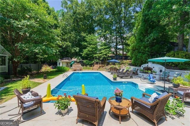 4010 Tamarack Dr NW, Kennesaw, GA 30152 - outdoor pool with a patio area, an outdoor structure, and a fenced backyard