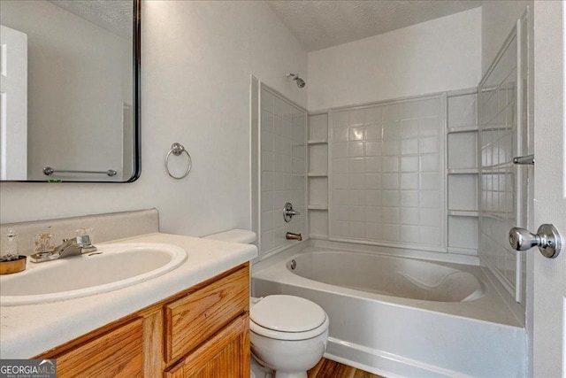 full bath with toilet, tub / shower combination, a textured ceiling, and vanity