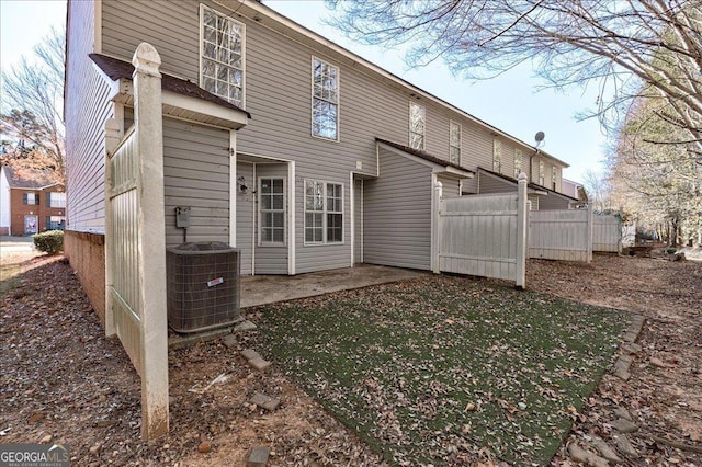 back of property with a patio area, fence, and central air condition unit