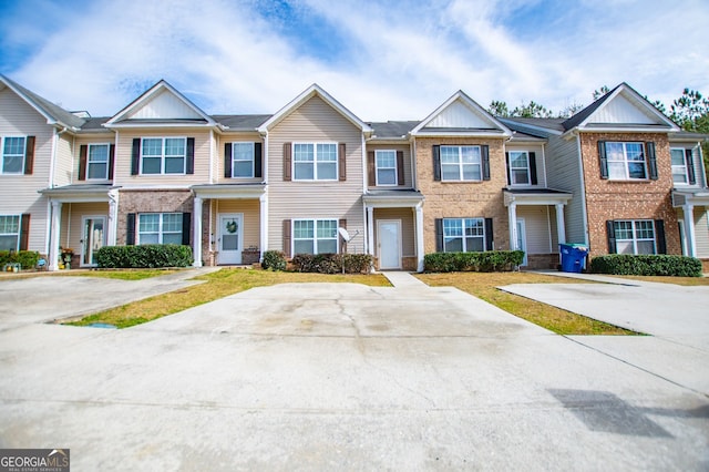 townhome / multi-family property featuring brick siding