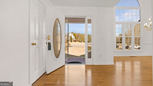 entrance foyer featuring a chandelier and light wood-style flooring