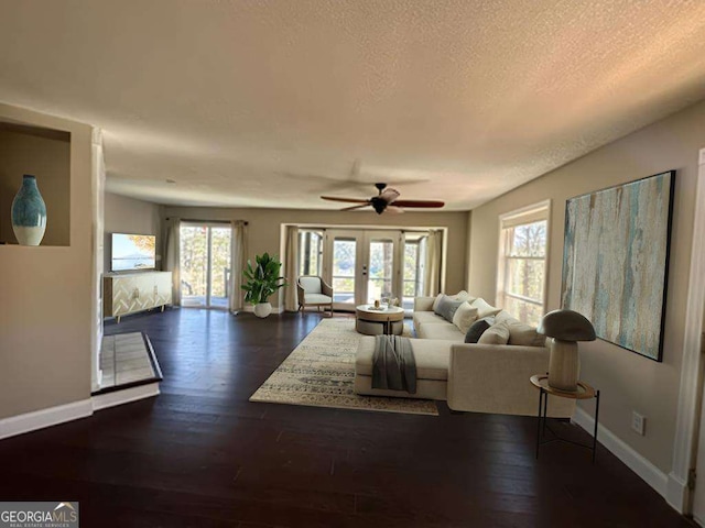 living room featuring plenty of natural light, dark wood finished floors, and baseboards