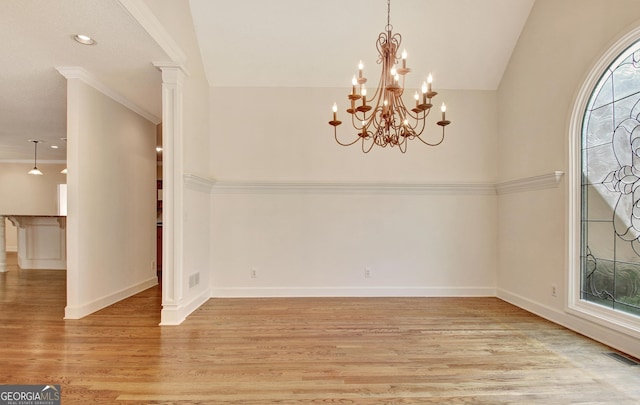 unfurnished dining area with lofted ceiling, visible vents, baseboards, light wood finished floors, and decorative columns